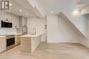 Toronto (Annex) multi-family for rent - A modern kitchen with wooden cabinets and a stainless steel oven.