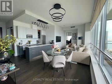 Toronto (Mimico) condo for rent - A modern kitchen with a dining table and chairs.