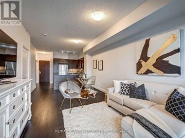 Oakville (Co Central) condo for rent - A living room with a white couch and a painting on the wall.