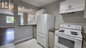 Hamilton (Strathcona) apartment for rent - A white refrigerator and stove in a kitchen.