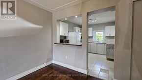 Hamilton (Strathcona) apartment for rent - A well-lit kitchen area with a refrigerator, cabinets, and a countertop.