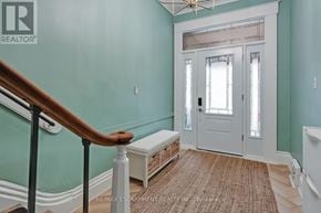 Hamilton (Central) apartment for rent - A hallway with a wooden staircase and a white door.