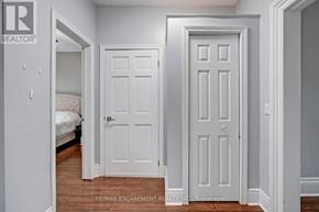 Hamilton (Central) apartment for rent - A white door is in a room with a bed in the background.