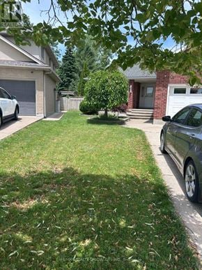 Niagara Falls (Mt. Carmel) apartment for rent - A white car is parked on the driveway of a house.