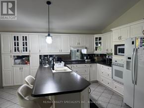 Niagara Falls (Mt. Carmel) apartment for rent - A kitchen with white cabinets and a black island.