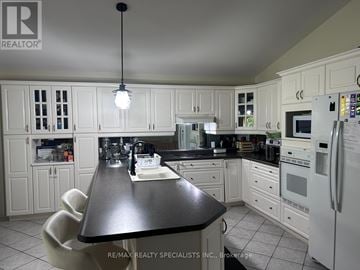 Niagara Falls (Mt. Carmel) apartment for rent - A kitchen with white cabinets and a black island.