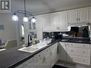 Niagara Falls (Mt. Carmel) apartment for rent - A kitchen with white cabinets and a black countertop.