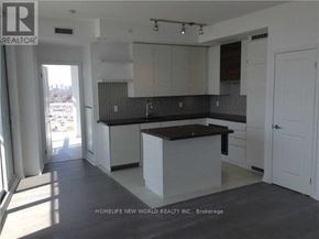 Toronto (Mimico) condo for rent - A kitchen with white cabinets and a black countertop.