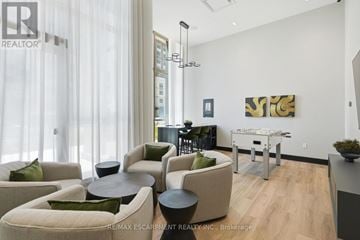 Oakville (Wm Westmount) condo for rent - A living room with a white sofa and a black table.