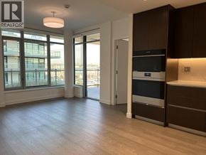 North Vancouver apartment for rent - A spacious kitchen with dark brown cabinets and a stainless steel oven.