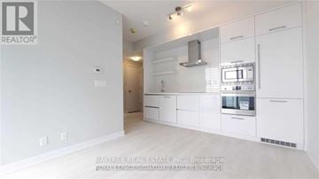 Toronto (Mount Pleasant West) condo for rent - A white kitchen with a microwave and oven built into the cabinetry.