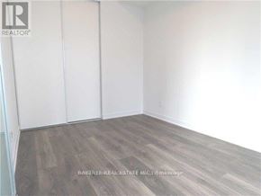 Toronto (Waterfront Communities) condo for rent - A room with wooden flooring and white walls.
