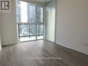Toronto (Waterfront Communities) condo for rent - A room with a large window and sliding glass doors.