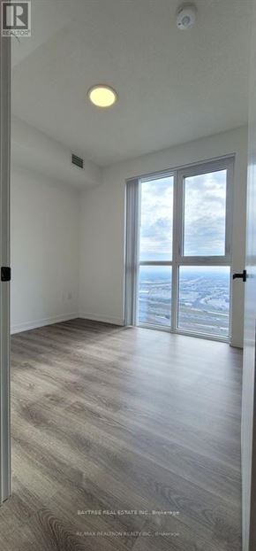 Vaughan (Vaughan Corporate Centre) condo for rent - A room with a large window and a sliding glass door.