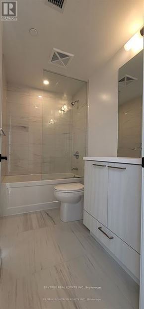 Vaughan (Vaughan Corporate Centre) condo for rent - A white bathroom with a toilet, sink, and bathtub.
