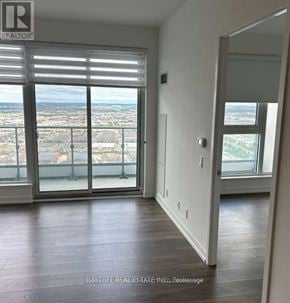 Vaughan (Vaughan Corporate Centre) condo for rent - A room with a view of the city through large windows.