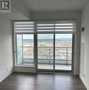 Vaughan (Vaughan Corporate Centre) condo for rent - A room with a view of the city through a large window.