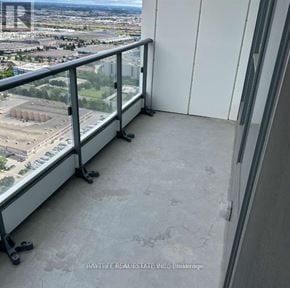 Vaughan (Vaughan Corporate Centre) condo for rent - A balcony with a glass railing overlooking a cityscape.