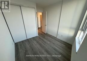 Toronto (Downsview-Roding-Cfb) condo for rent - A room with a wooden floor and white walls.