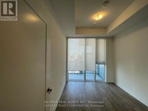 Toronto (Waterfront Communities) condo for rent - A room with a sliding glass door leading to a balcony.