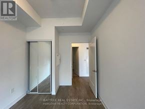 Toronto (Waterfront Communities) condo for rent - A hallway with a glass door and a white wall.