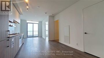 Vaughan (Vaughan Corporate Centre) condo for rent - A spacious kitchen with white cabinets and a large island.