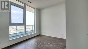 Vaughan (Vaughan Corporate Centre) condo for rent - A real estate listing image of a room with a large window overlooking a beach.