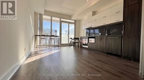 Markham (Unionville) condo for rent - A spacious kitchen with dark wood cabinets and a modern design.