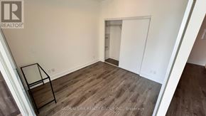 Markham (Unionville) condo for rent - A room with wooden flooring and white walls, with a glass table in the corner.