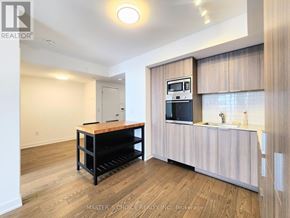 Toronto (Bay Street Corridor) condo for rent - A kitchen area with a microwave, oven, and sink.