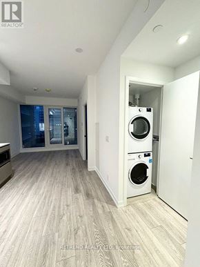 Toronto (Waterfront Communities) condo for rent - A laundry room with a washer and dryer in it.