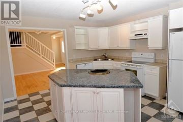 Ottawa apartment for rent - A kitchen with white cabinets and a granite countertop.