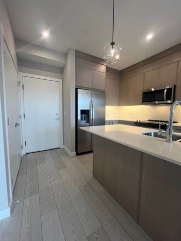 Calgary apartment for rent - A kitchen with a sink and a refrigerator.