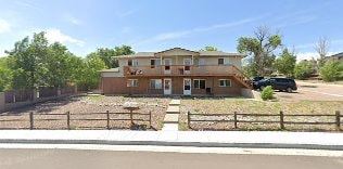 Colorado Springs apartment for rent - A brown house with a fence in front of it.
