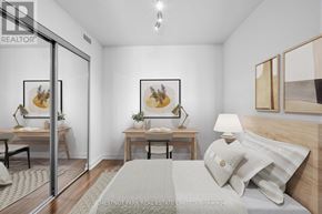 Toronto (Niagara) condo for rent - A bedroom with a bed, two nightstands, and a painting on the wall.