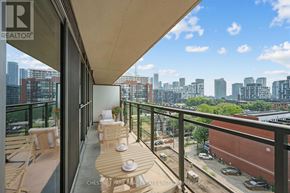 Toronto (Niagara) condo for rent - A balcony with a table and chairs overlooking a cityscape.
