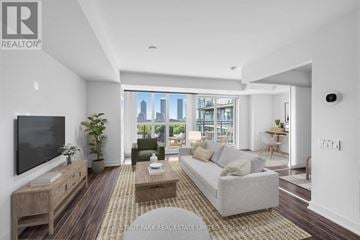 Toronto (Niagara) condo for rent - A living room with a couch, a coffee table, and a television.
