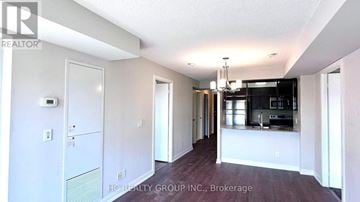 Toronto (Agincourt South-Malvern West) condo for rent - A spacious kitchen and dining area with white walls and a wooden floor.