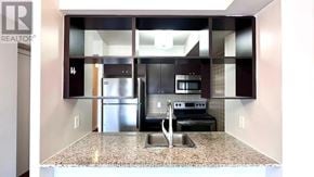 Toronto (Agincourt South-Malvern West) condo for rent - A kitchen with granite countertops and stainless steel appliances.
