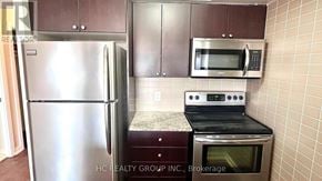Toronto (Agincourt South-Malvern West) condo for rent - A kitchen with a stainless steel refrigerator, microwave, and oven.