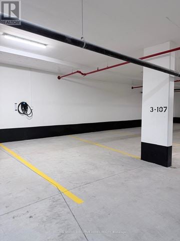 Milton (Cb Cobban) condo for rent - A parking garage with the number 3-107 on the wall.
