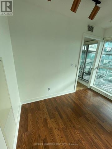 Toronto (Niagara) condo for rent - A room with wooden floors and white walls.