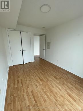 Toronto (Niagara) condo for rent - A room with wooden flooring and white walls.