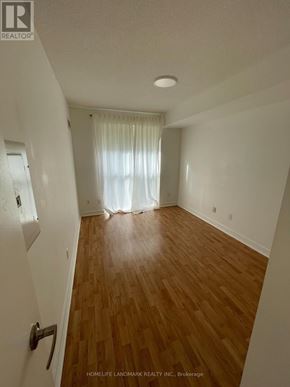 Toronto (Niagara) condo for rent - A room with wooden flooring and white walls.