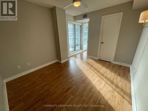 Toronto (Niagara) condo for rent - A room with wooden flooring and a sliding glass door.