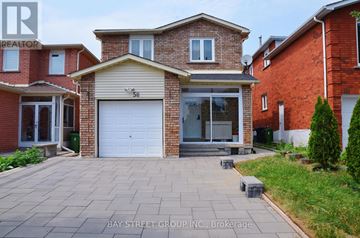 Toronto (Milliken) apartment for rent - A house with a garage and a driveway in front of it.
