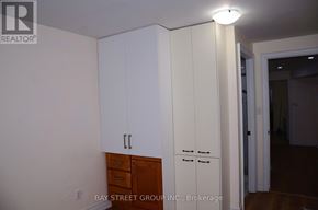Toronto (Milliken) apartment for rent - A white cabinet with a drawer is in the middle of a room.