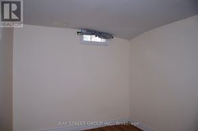 Toronto (Milliken) apartment for rent - A room with a brokerage logo on the wall.