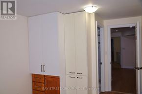 Toronto (Milliken) apartment for rent - A white cabinet with a drawer is in the foreground of an empty room.
