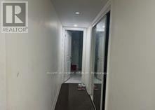 Toronto (Oakridge) apartment for rent - A hallway with a glass door and a white wall.